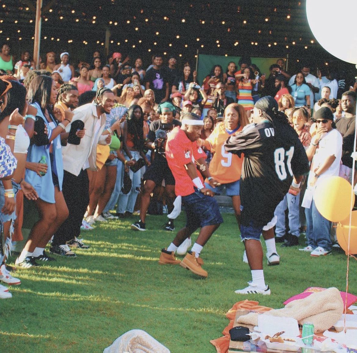 Outdoor festival with dancing and string lights